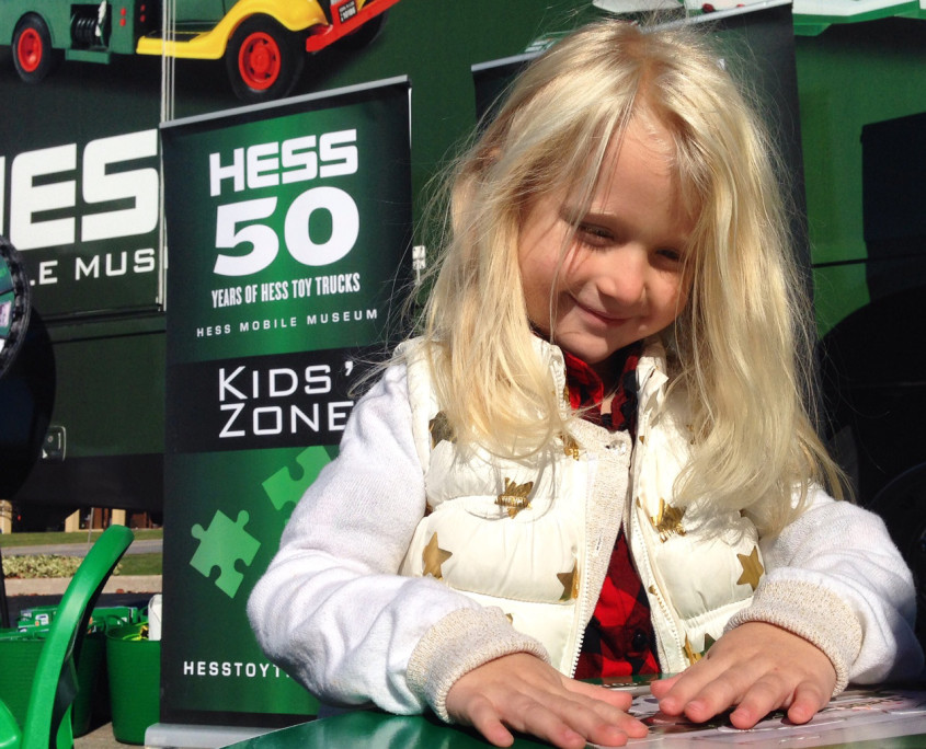 A young girl enjoys the games offered at the Hess Mobile Museum's Kids' Zone.